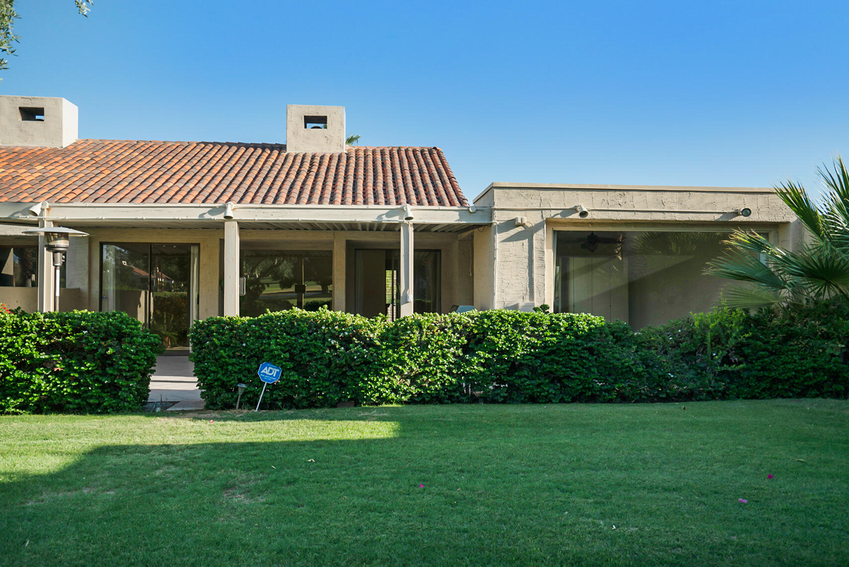 137 Desert W Drive Rancho Mirage, CA 92270 - Photo 50 of 56 a front view of a house with a yard