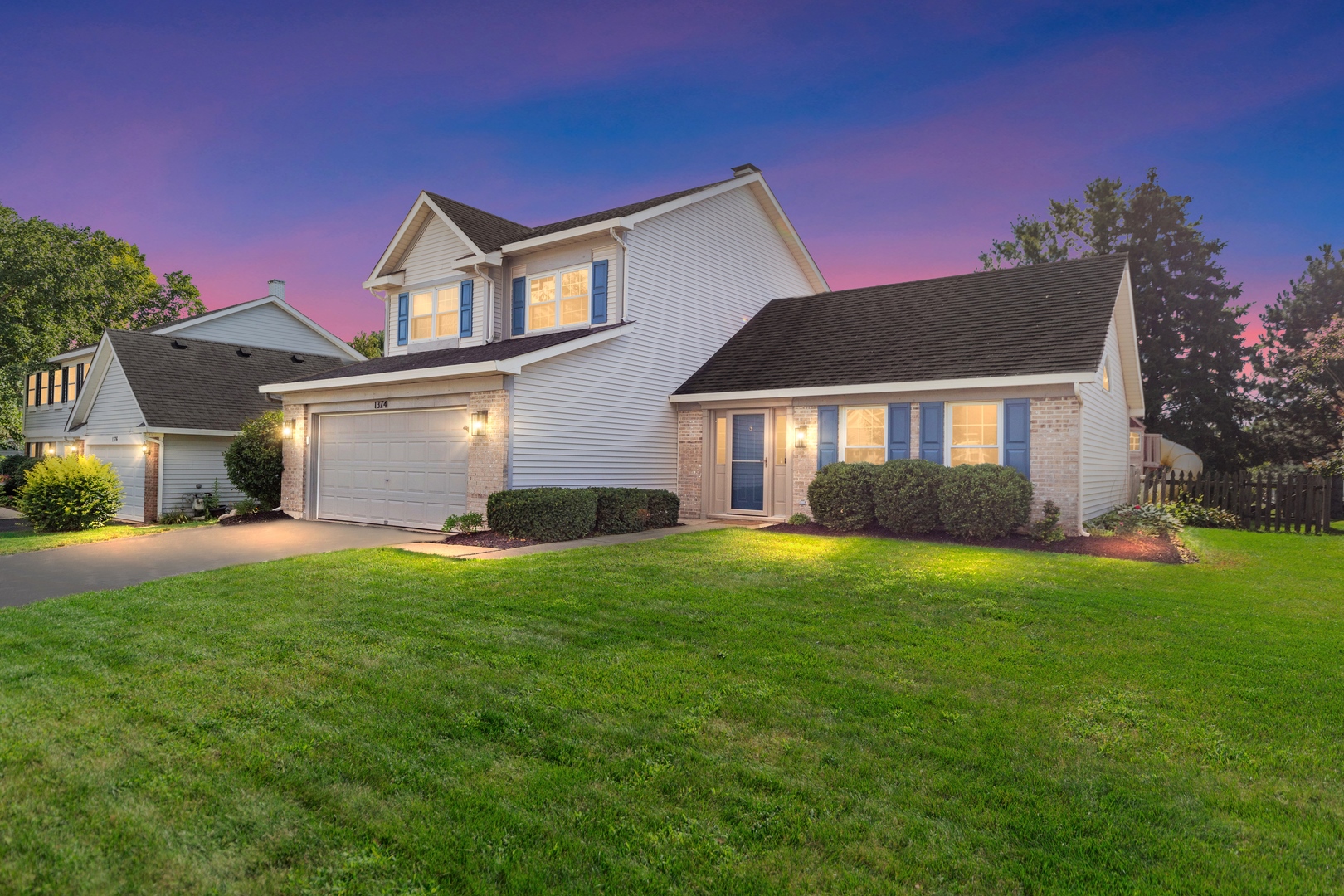 1374 Northgate Drive Bartlett, IL 60103 - Photo 1 of 38 a front view of a house with a garden and yard