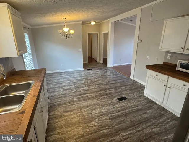 a kitchen with a sink stove and refrigerator