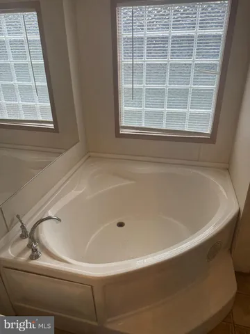 a white bath tub sitting next to a window