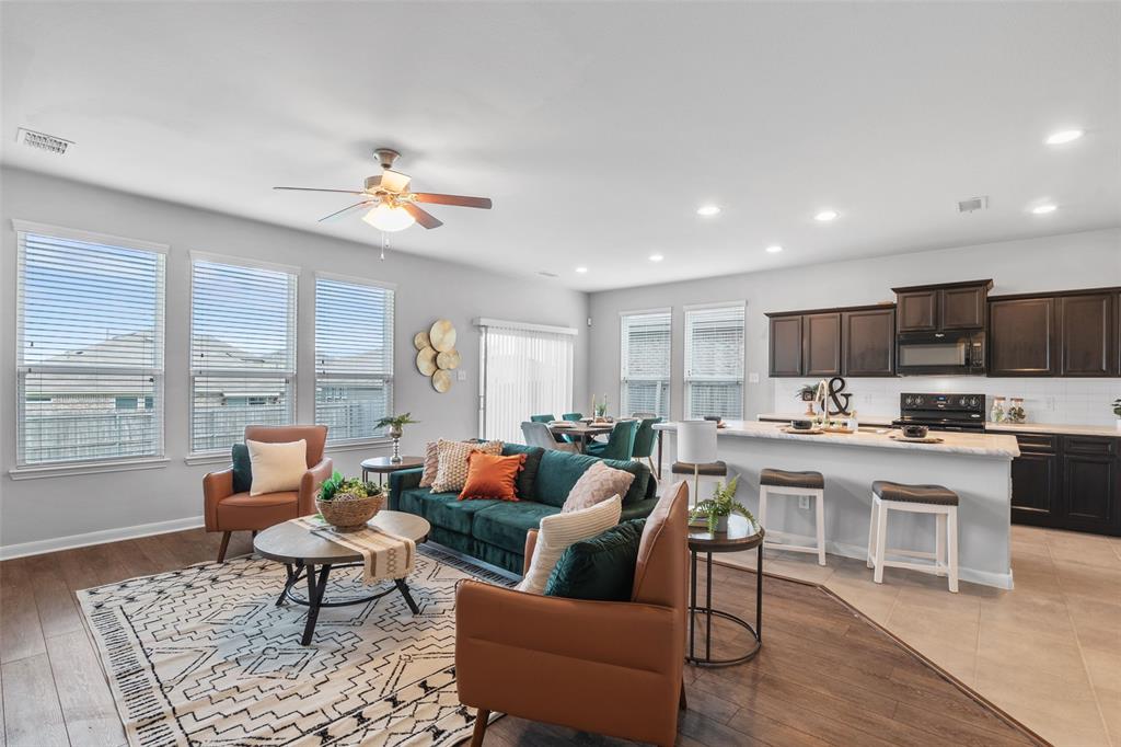 4650 Elderberry Street Forney, TX 75126 - Photo 8 of 31 a living room with furniture kitchen view and a large window