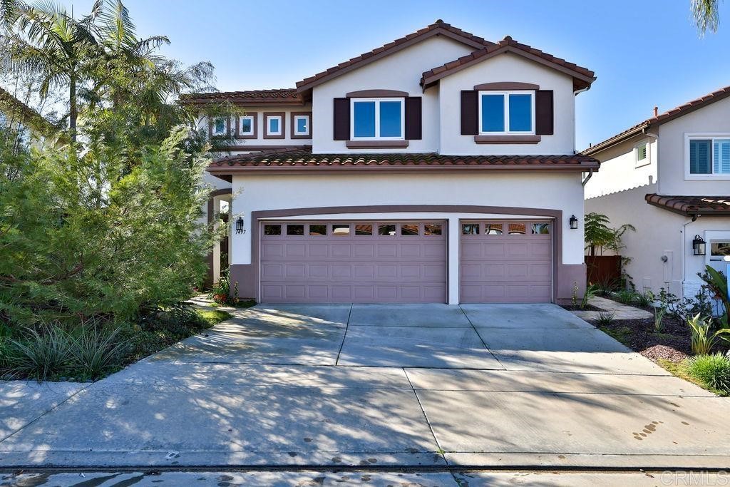 a front view of a house with a yard and a garage