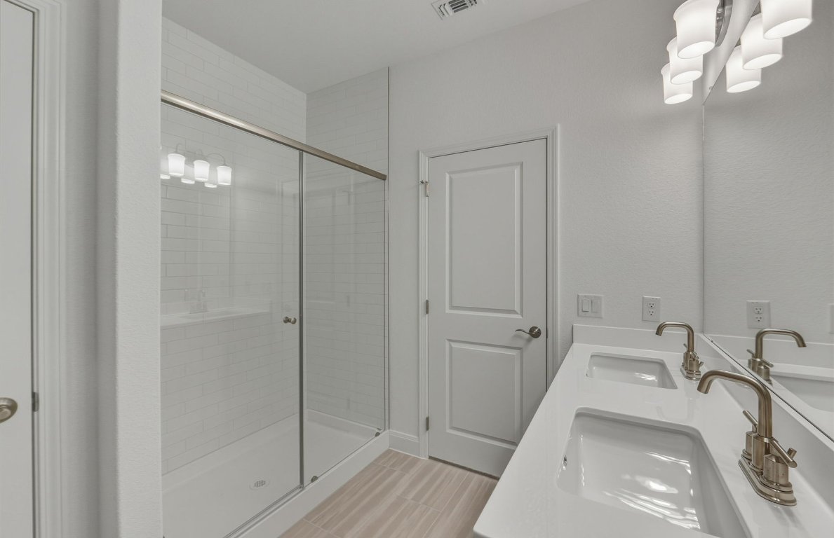 216 Daniels Dusty Trail Georgetown, TX 78626 - Photo 9 of 23 a bathroom with a sink and a mirror