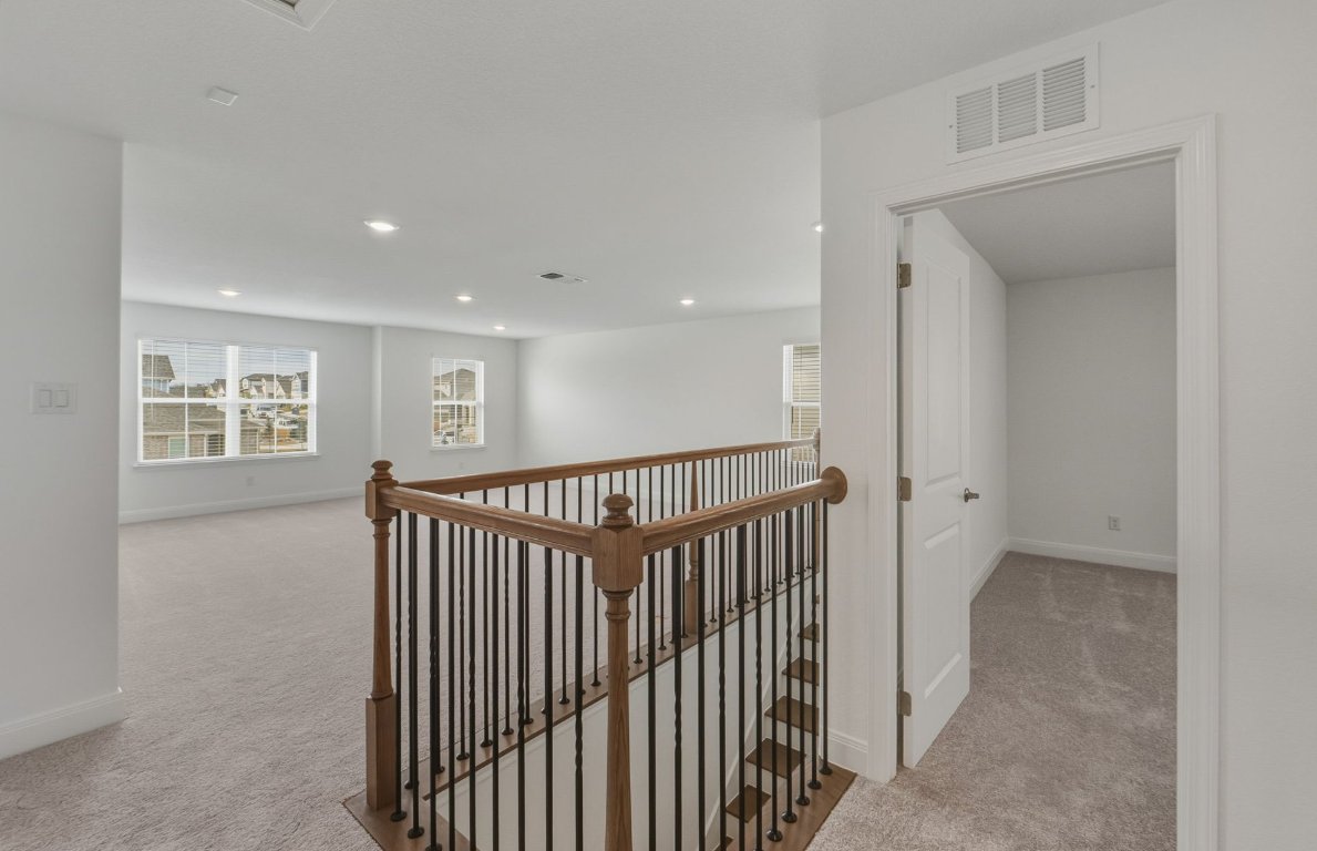 216 Daniels Dusty Trail Georgetown, TX 78626 - Photo 14 of 23 a view of a hallway with windows