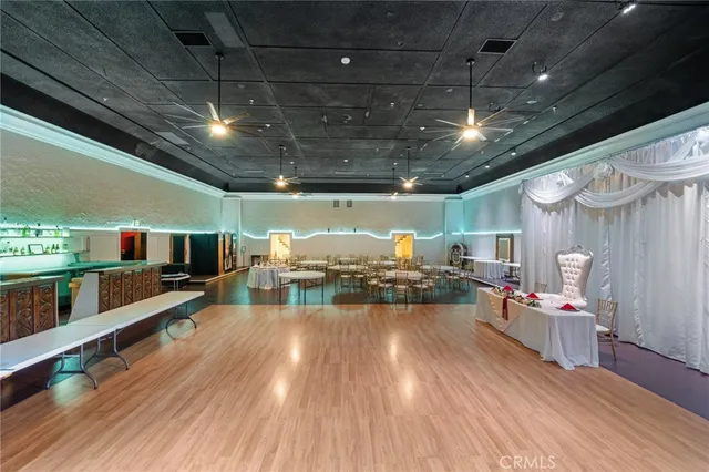 a living room with lots of furniture and a large window