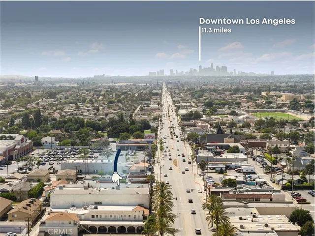 a view of a white building with glass windows