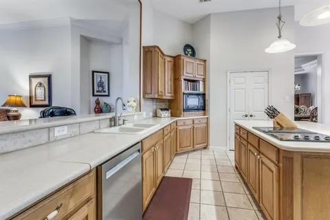 a kitchen with stainless steel appliances a sink stove and cabinets