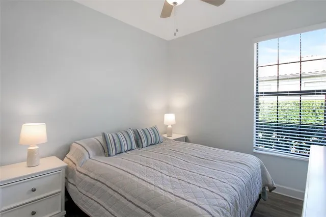 a view of a bedroom with wooden floor and bed