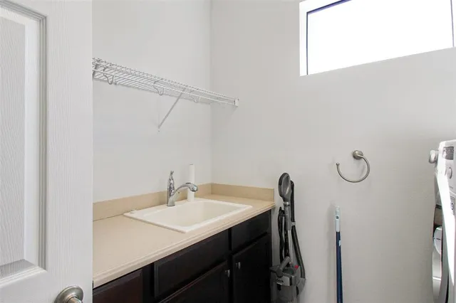 a bedroom with a bed and a lamp on the dresser