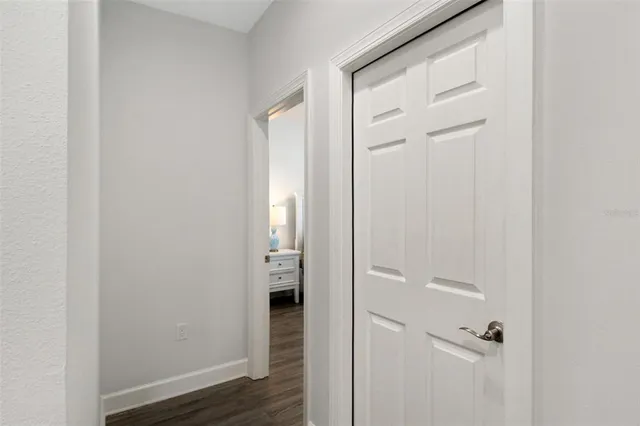 a bedroom with a bed and a mirror on the dresser