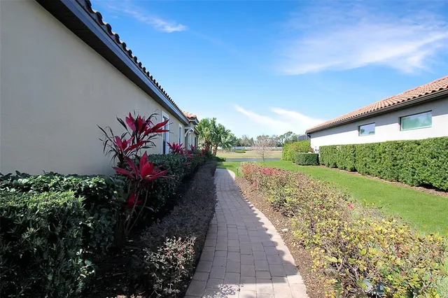 a view of a street with a flower garden in front of it