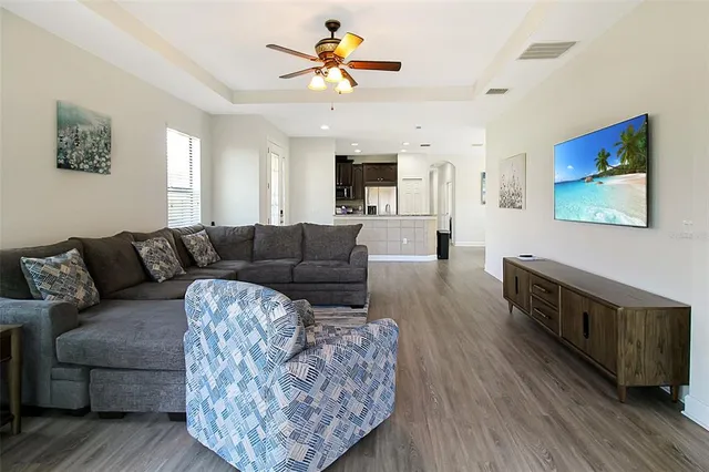 a view of a bedroom with a bed and wooden floor