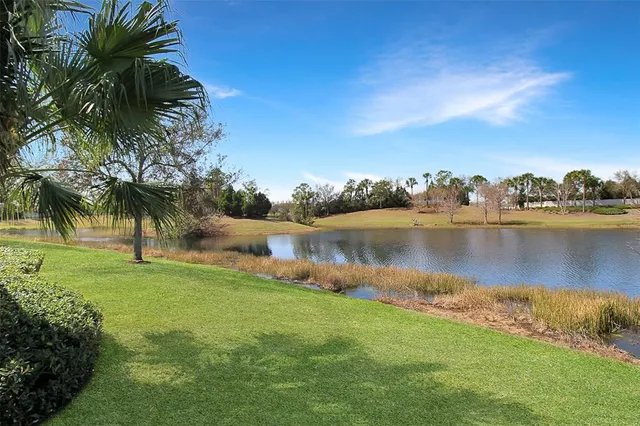 a view of a lake with houses in the back
