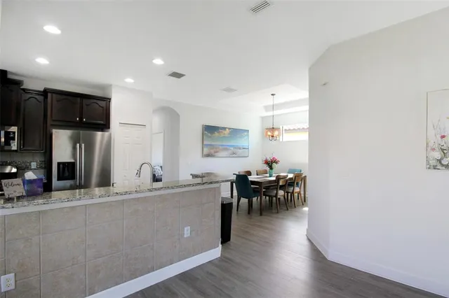 a view of a dining room with furniture wooden floor and a chandelier