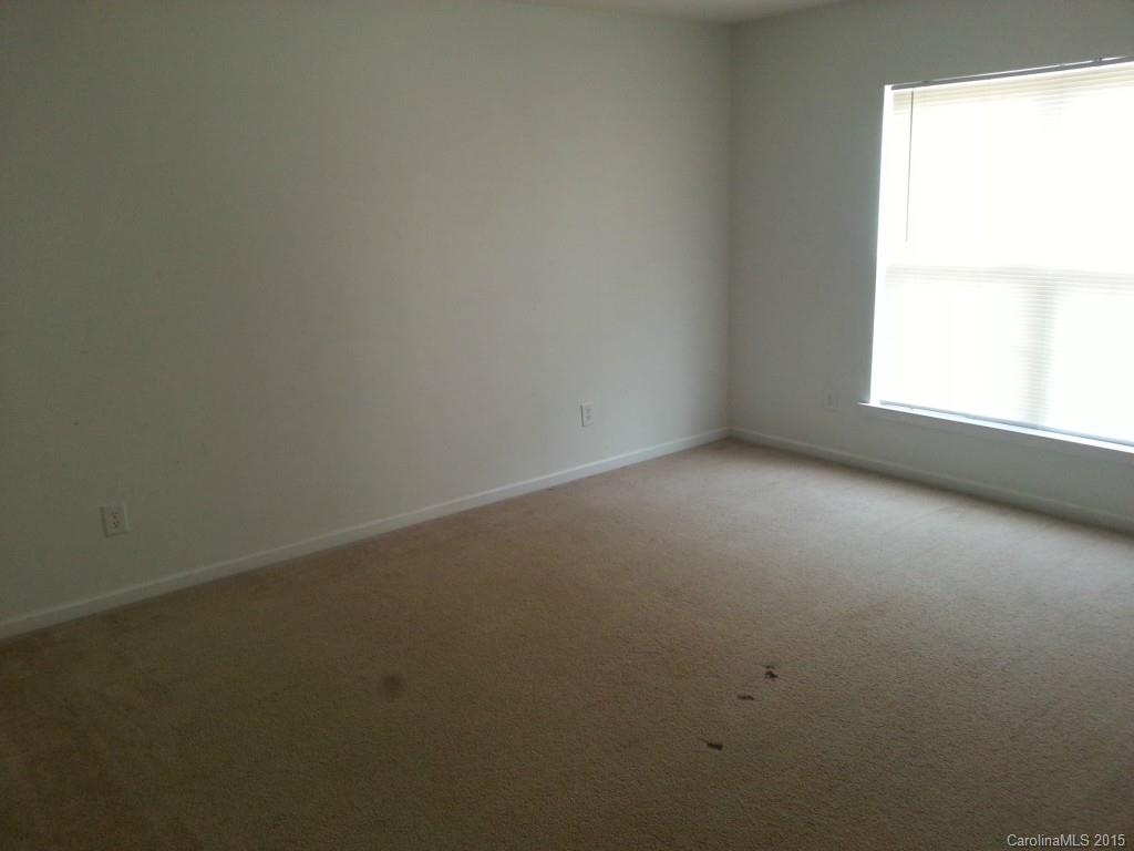 8931 Foggy Meadow Road Charlotte, NC 28269 - Photo 12 of 13 an empty room with a window