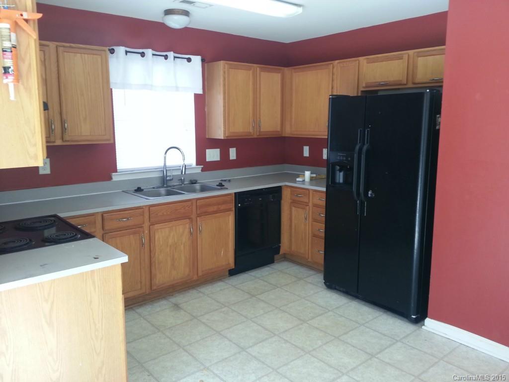 8931 Foggy Meadow Road Charlotte, NC 28269 - Photo 4 of 13 a kitchen with stainless steel appliances granite countertop a refrigerator and a sink