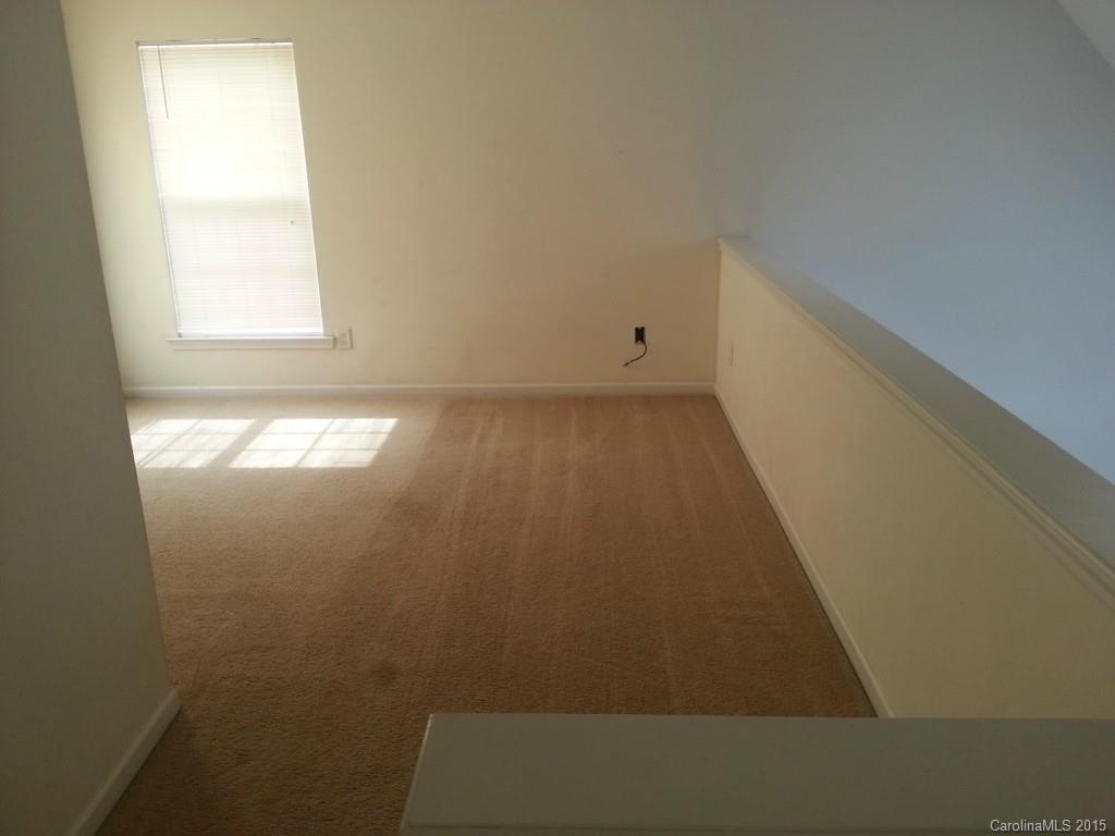 8931 Foggy Meadow Road Charlotte, NC 28269 - Photo 9 of 13 an empty room with a window