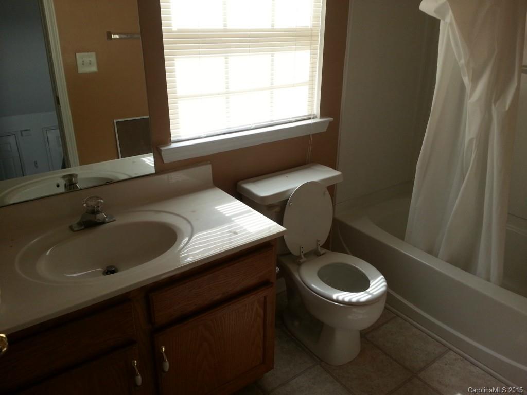 8931 Foggy Meadow Road Charlotte, NC 28269 - Photo 10 of 13 a bathroom with a sink a toilet and a window