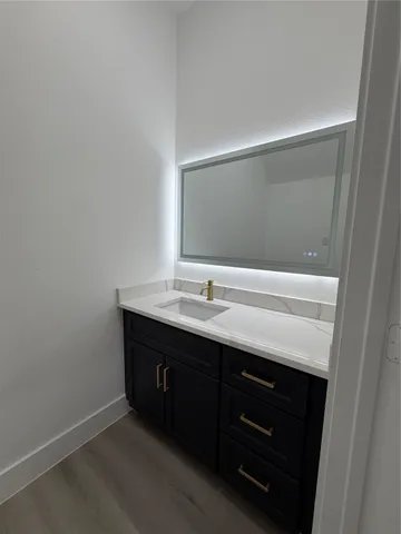 a view of kitchen with a sink and a stove top oven