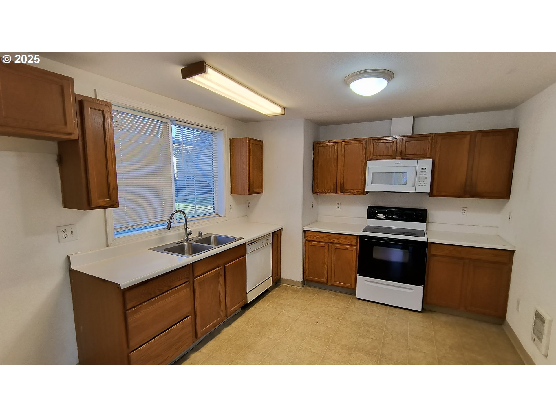 2915 Northeast Stapleton Road Vancouver, WA 98661 - Photo 6 of 17 a kitchen with stainless steel appliances kitchen island granite countertop a sink counter space and cabinets