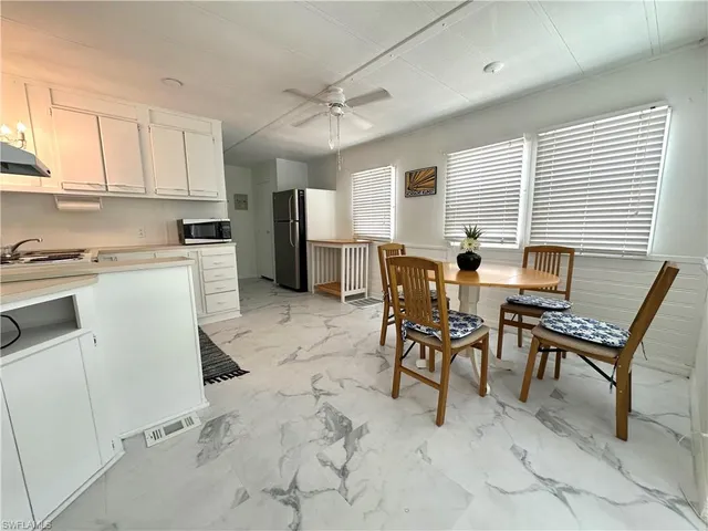 a view of a dining room that has a table and chairs in it
