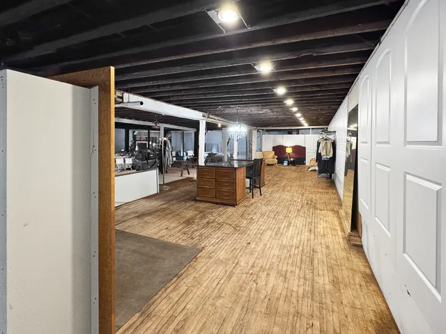 a large white kitchen with sink and stainless steel appliances