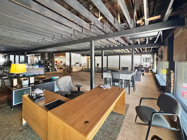 a large kitchen with stainless steel appliances granite countertop a lot of counter space and wooden floors