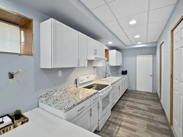 a bathroom with a toilet sink vanity and mirror