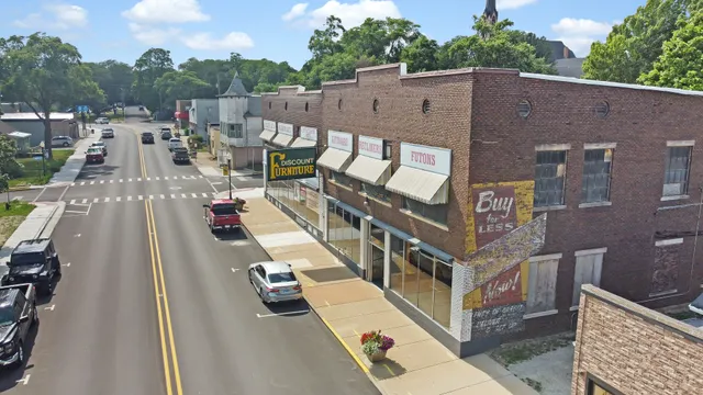 an aerial view of a brick building with a yard