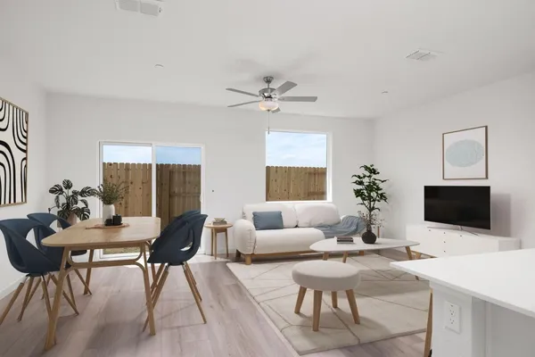 a living room with furniture a flat screen tv and a potted plant