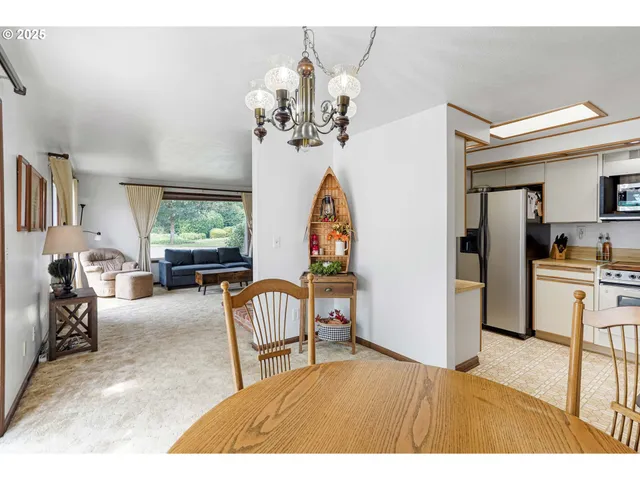 a kitchen with a sink a refrigerator and cabinets