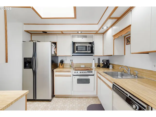 a kitchen with a refrigerator and a sink