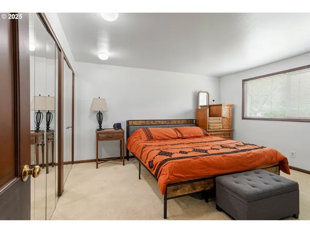 a bedroom with a bed and a dresser