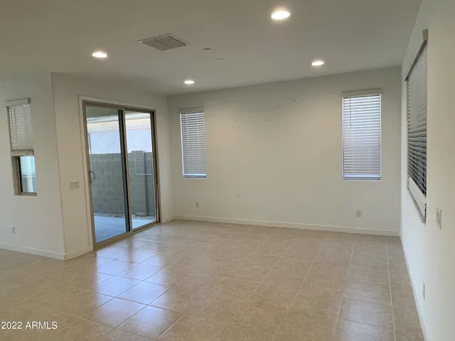 an empty room with windows and closet