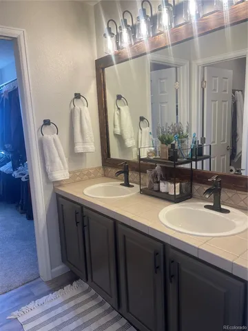 a bathroom with a double vanity sink and a mirror