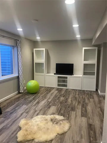a view of a livingroom with wooden floor and chair
