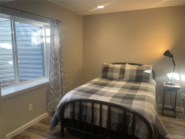 a bedroom with a bed and window