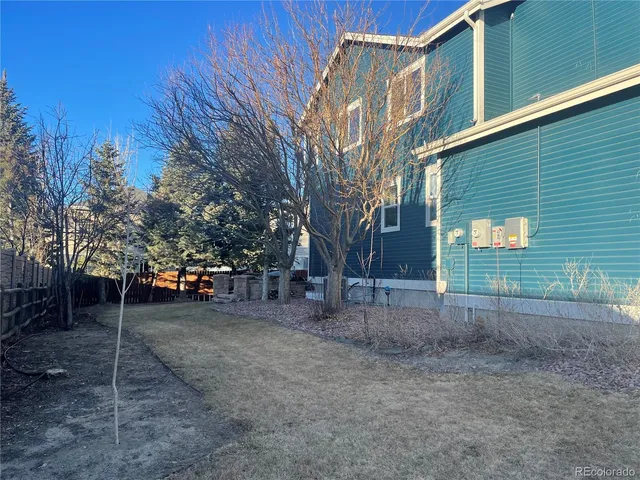 a view of a yard with snow on the road