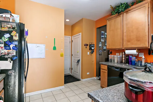 a kitchen with stainless steel appliances granite countertop a refrigerator and a stove