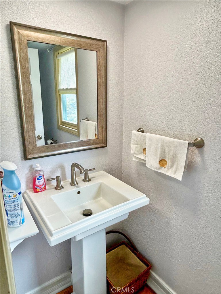 258 West Escalones, Unit 6R San Clemente, CA 92672 - Photo 13 of 37 a bathroom with a sink a toilet and mirror
