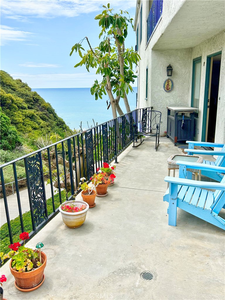 258 West Escalones, Unit 6R San Clemente, CA 92672 - Photo 16 of 37 a view of a chairs and table in backyard