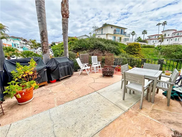 a view of a patio with a table and chairs and potted plants