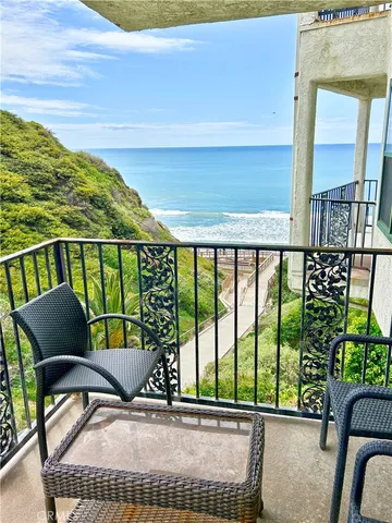 a balcony with table and chairs