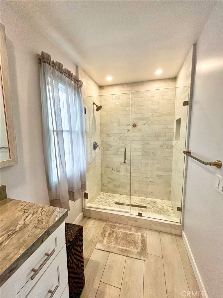 258 West Escalones, Unit 6R San Clemente, CA 92672 - Photo 21 of 37 a bathroom with a granite countertop sink toilet and shower