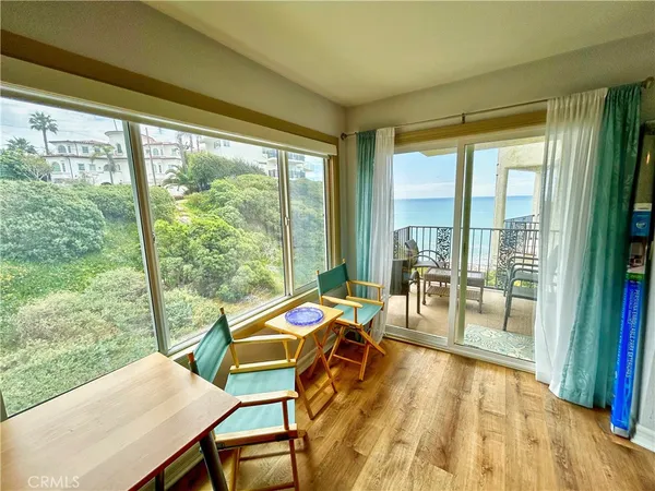 a room with a balcony view and wooden floor