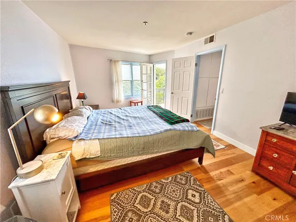 a bedroom with a bed and a mirror