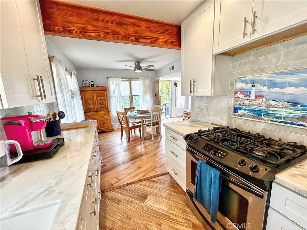 258 West Escalones, Unit 6R San Clemente, CA 92672 - Photo 5 of 37 a kitchen with stainless steel appliances granite countertop a stove a sink and a refrigerator