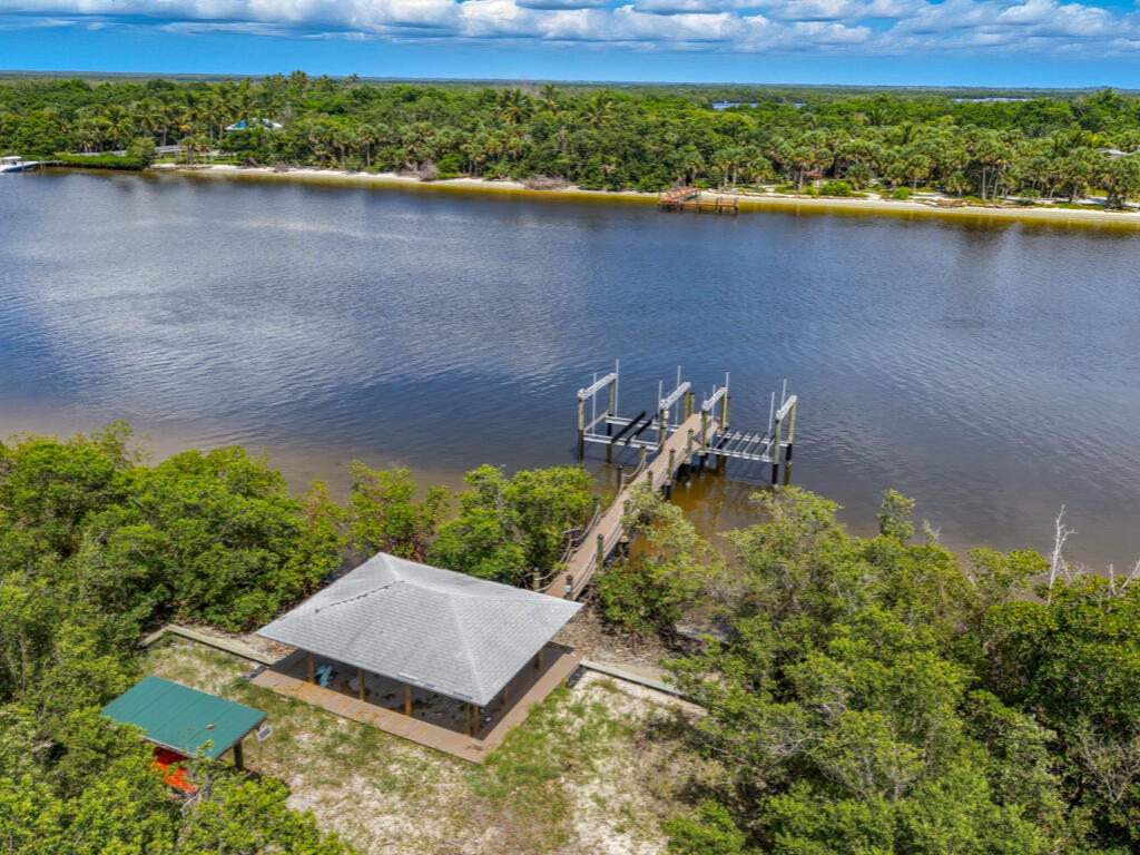 0 Keewaydin Naples, FL 34113 - Photo 13 of 18 an aerial view of a house with a yard and lake view