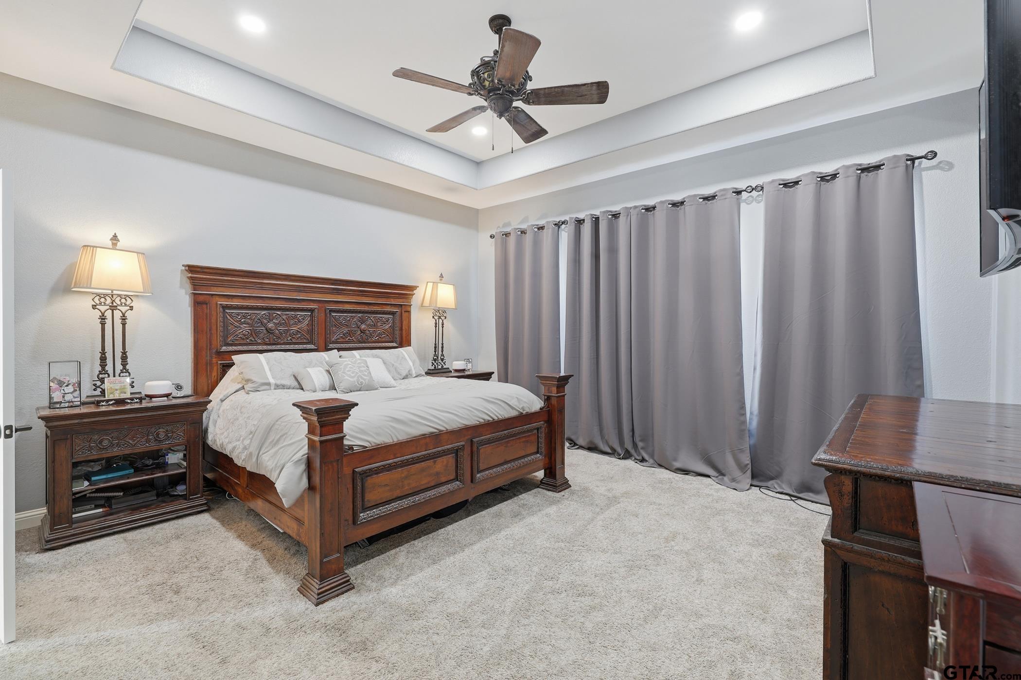 847 Calloway Road Marshall, TX 75670 - Photo 12 of 33 a bedroom with a bed and a chandelier