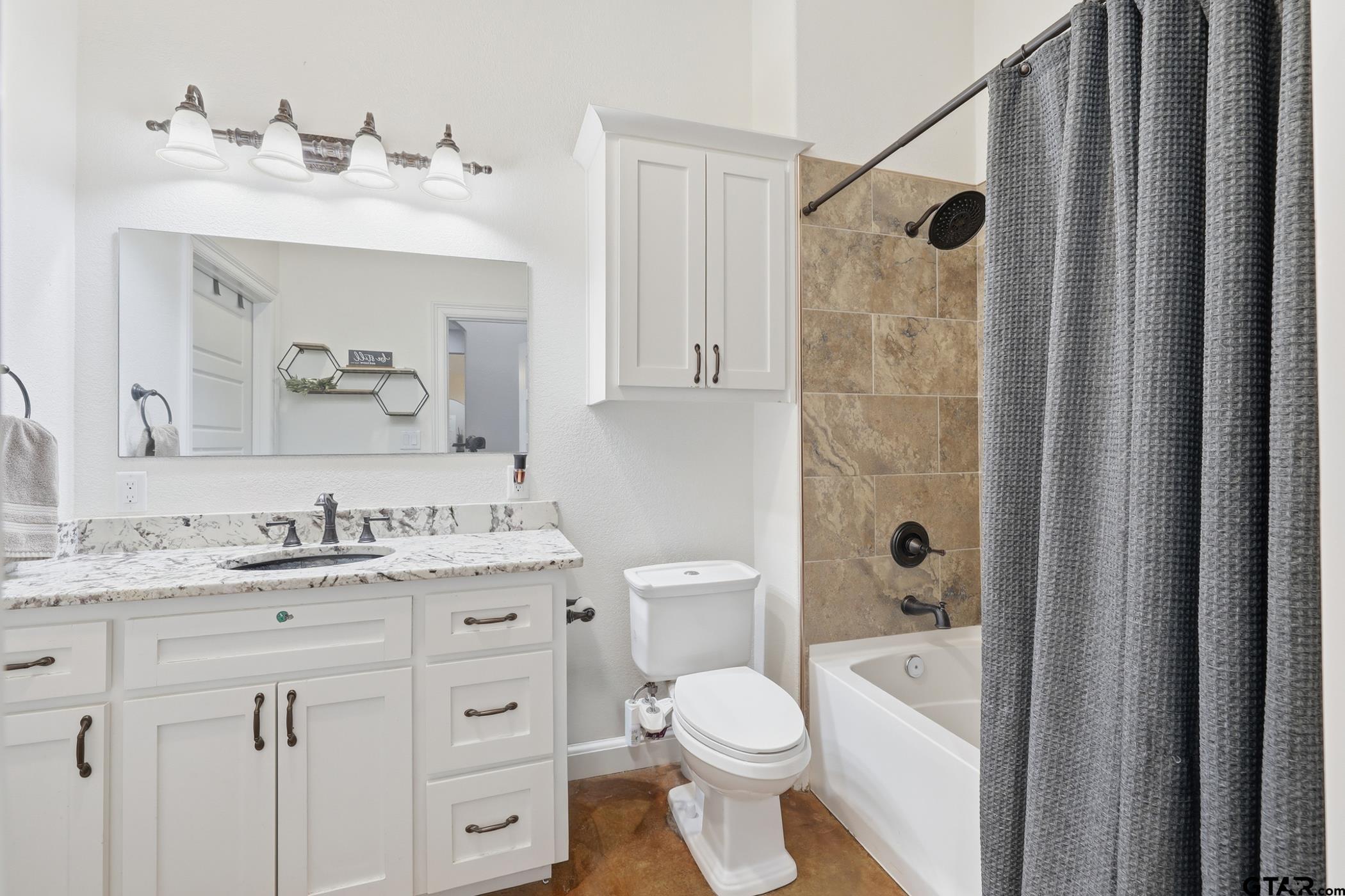 847 Calloway Road Marshall, TX 75670 - Photo 17 of 33 a bathroom with a granite countertop sink toilet a mirror a vanity and shower